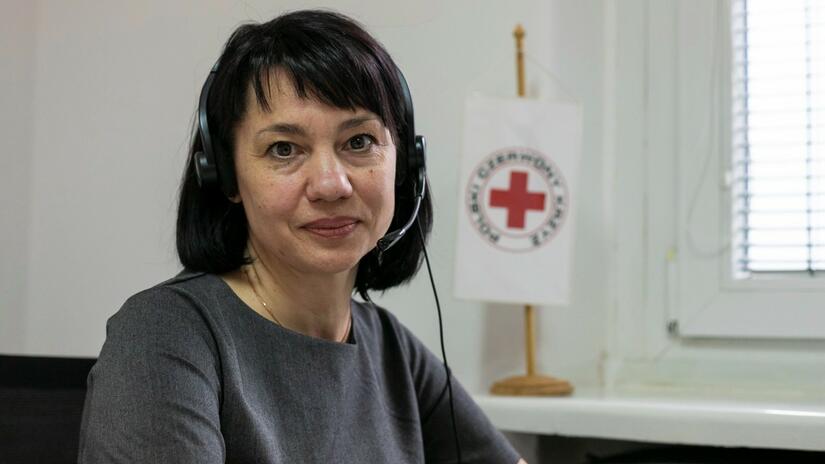 Alla Karapeichyk, a psychologist from Ukraine, sits and answers calls to the Information Line of the Polish Red Cross.