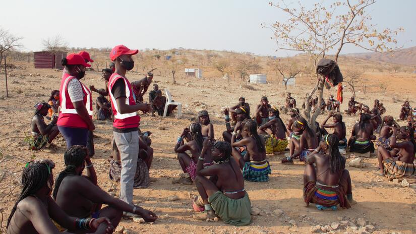 Namibian Red Cross Society volunteers speak to a group of people who have arrived on foot from Angola to escape drought conditions.