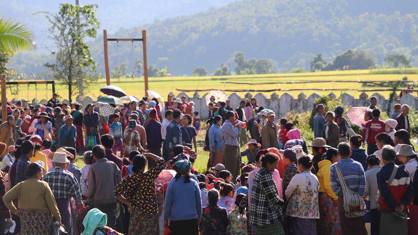 People gather to receive assistance from the Myanmar Red Cross in the Magway region of Myanmar.