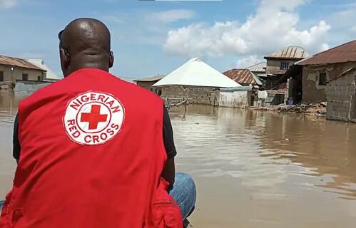 A Nigeria Red Cross Society volunteer from Kogi branch surveys the damage to his community due to heavy flooding in October 2022.