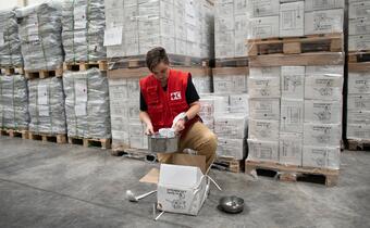 IFRC Deputy Head of Operations for the Ukraine response inspects humanitarian relief items in a logistics warehouse in Debrecen, Hungary close to the border with Ukraine, in March 2022.