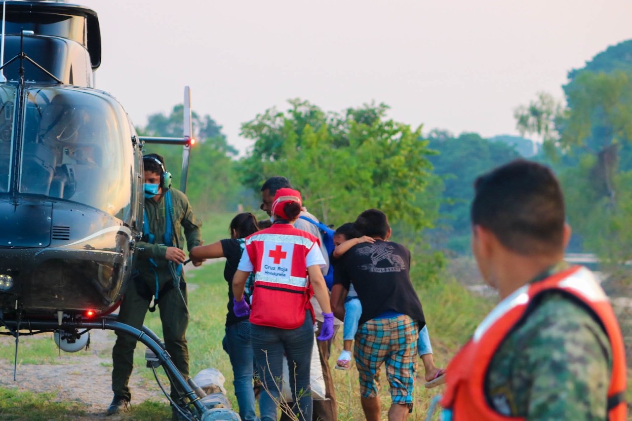Honduran Red Cross Volunteers help transport a family to safety in a helicopter following devastating Hurricane Eta in November 2020