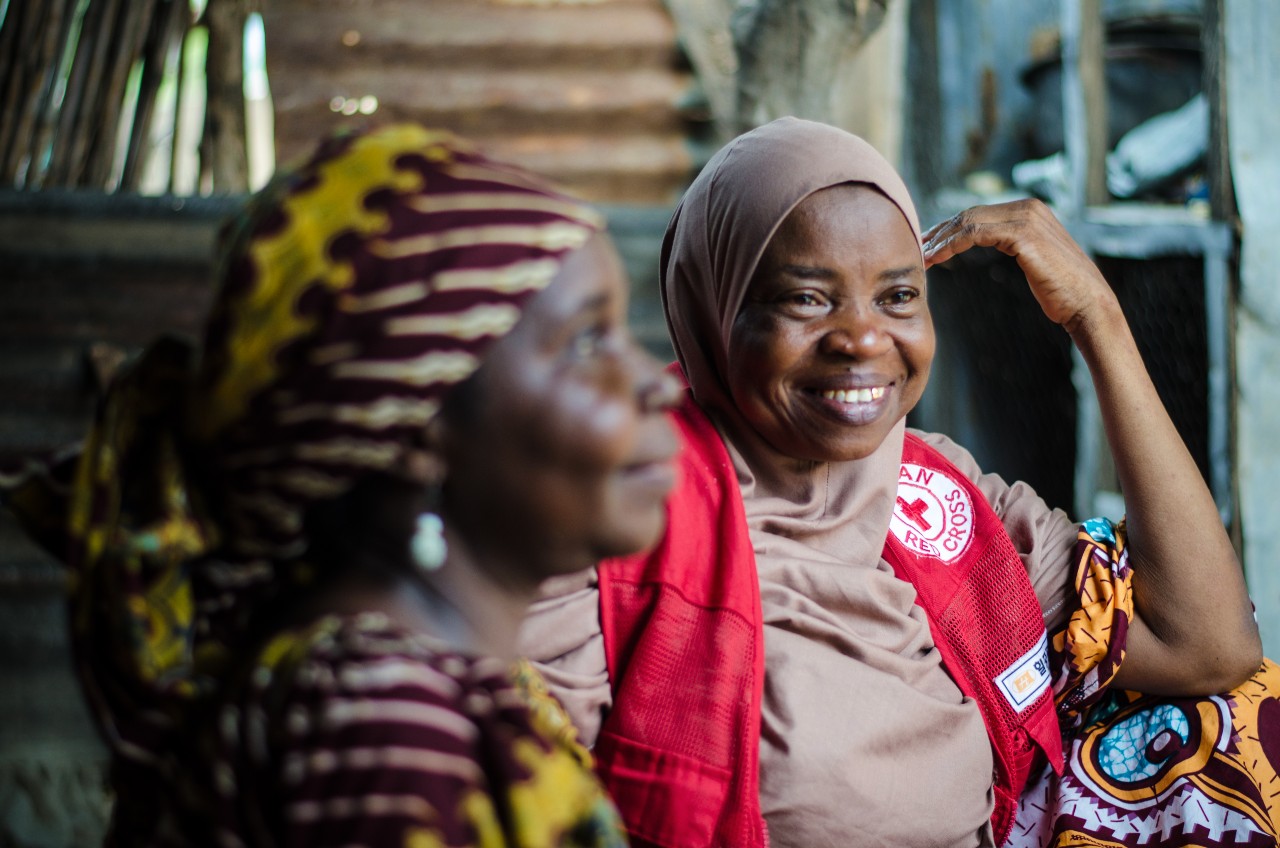 A woman speaks to the Nigerian Red Cross divisional secretary of Song, Nigeria about her family escaping conflict and the new livelihood she has set up using cash assistance