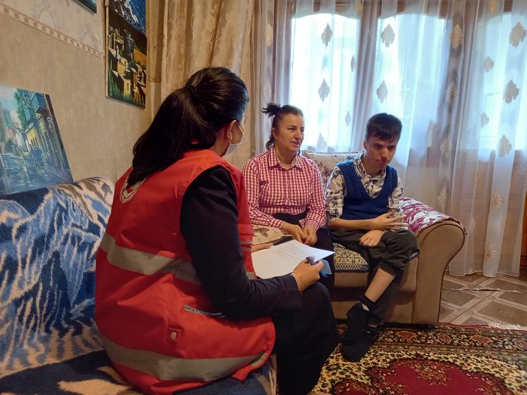 A Red Crescent volunteer meets with Şiriyeva and her son Fuad