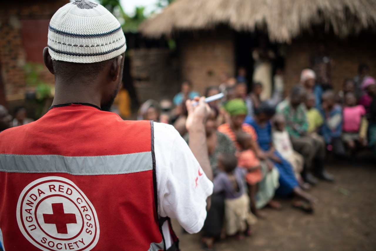 A volunteer from the Ugandan Red Cross speaks to communities about how to recognise early signs of disease outbreaks to help people stay safe from Ebola and other health threats