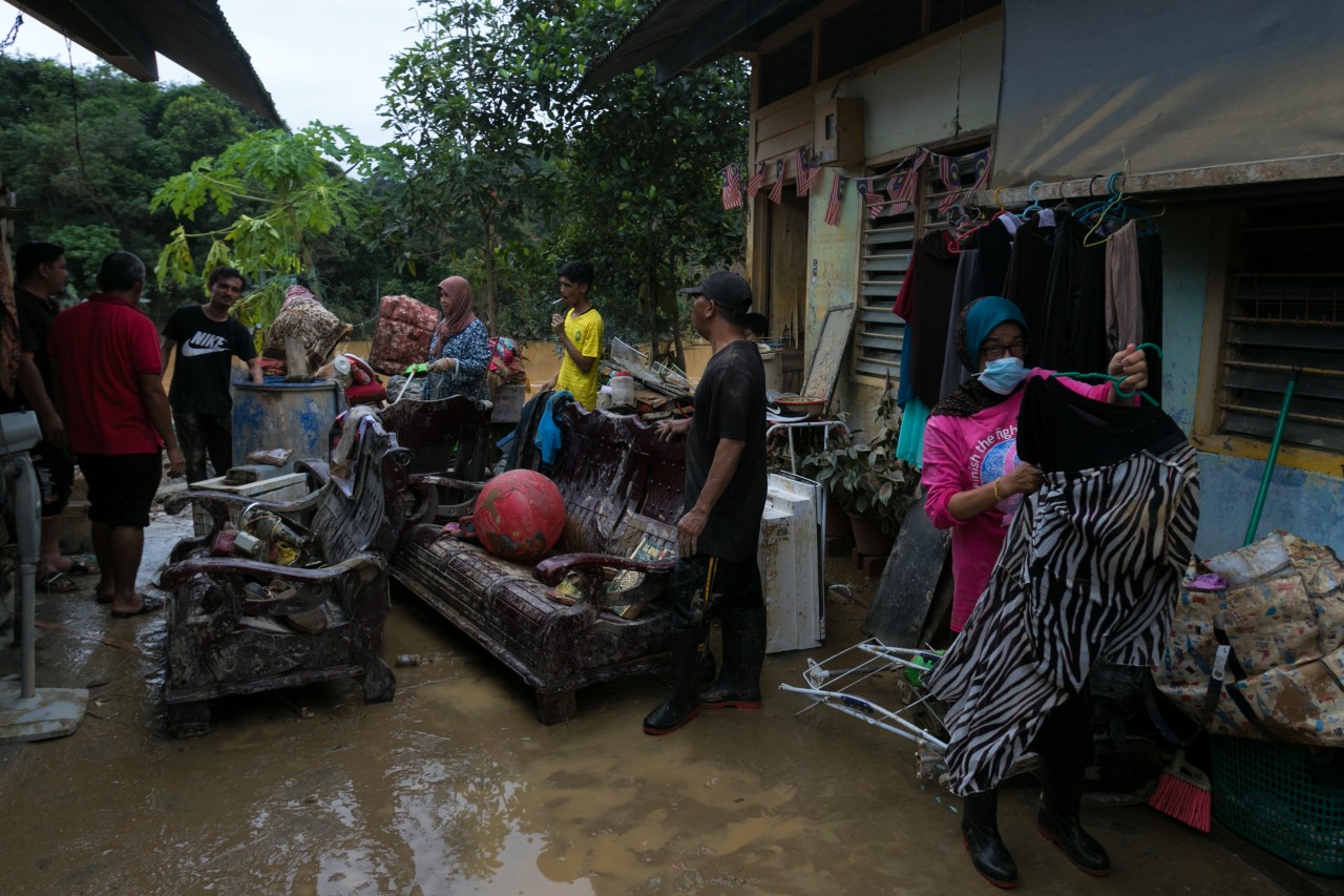 People in Terengganu, Malaysia inspect damage to their possessions after their homes were affected by heaving flooding in summer 2021