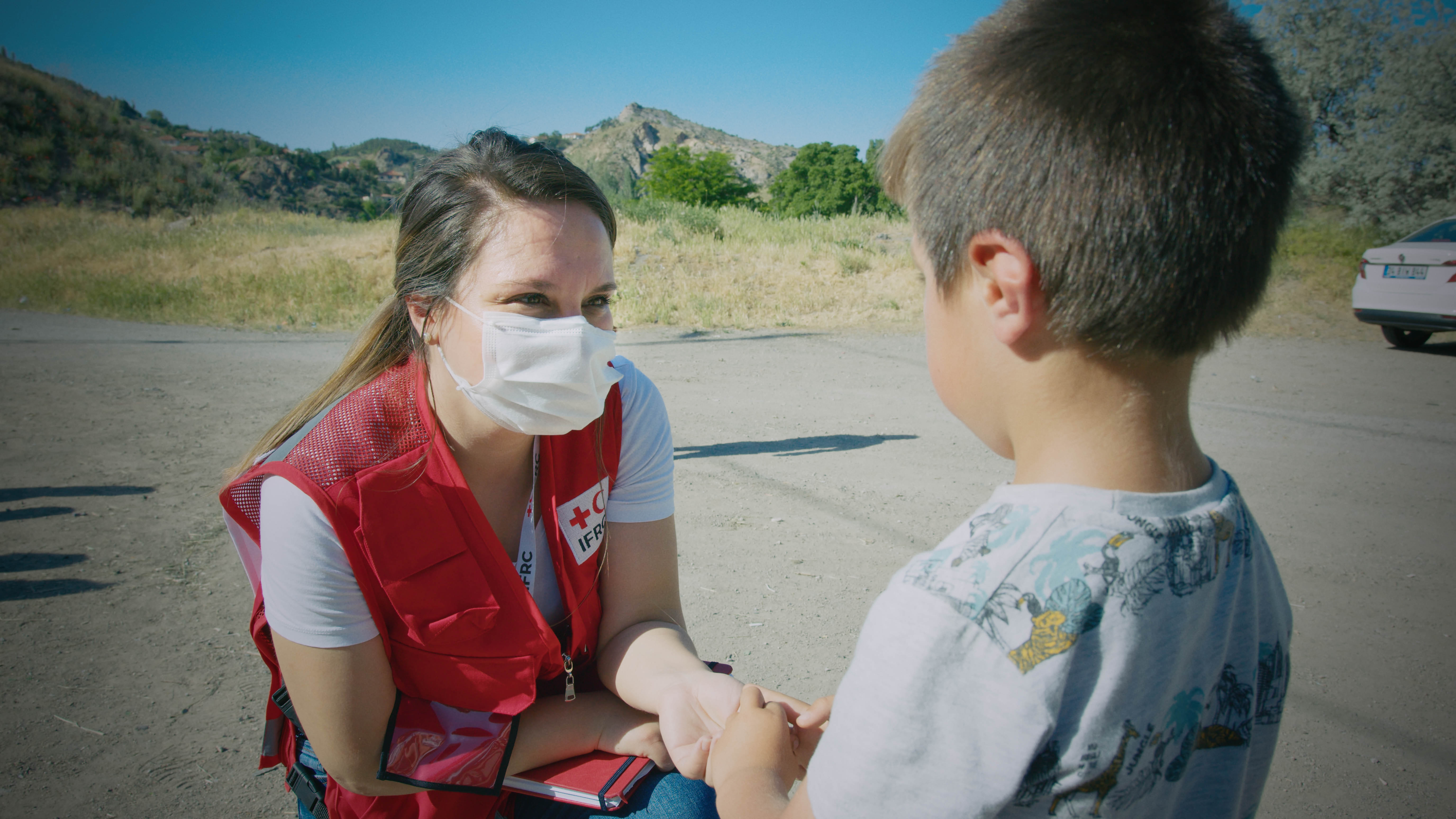 Deniz engaging with a young Syrian receiving ESSN