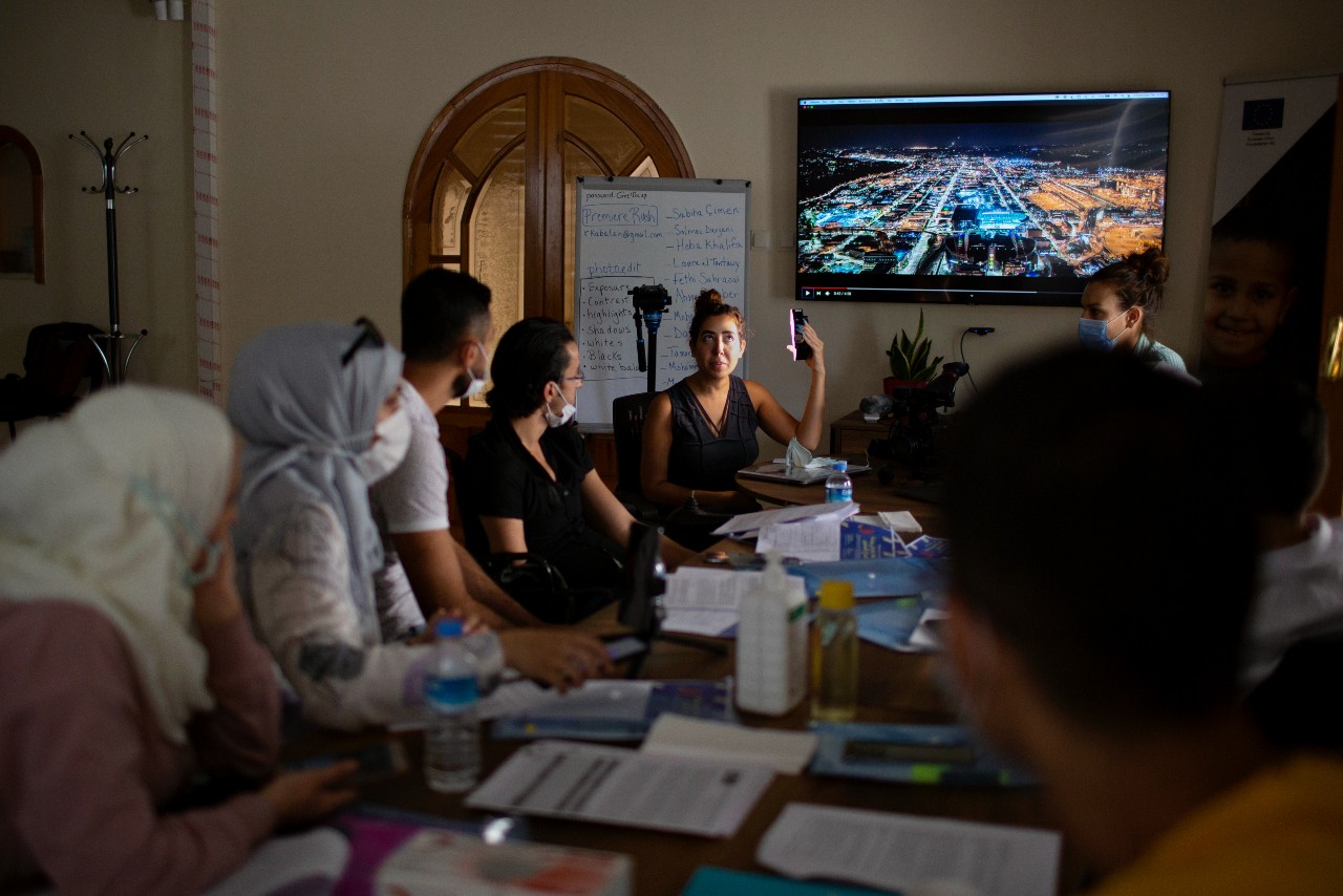 Participants of the ESSN storytelling project gather together at a workshop to learn new communications and storytelling skills