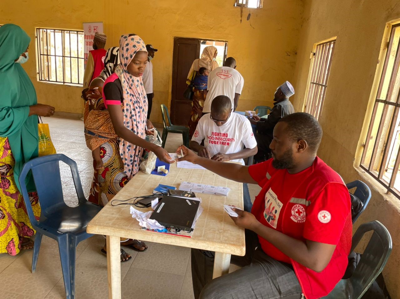 Mothers receives cash at IFRC Cash Voucher assistance distribution in Lapai LGA, Niger State. This cash assistance will enable them to buy the food they need to feed themselves and their children.