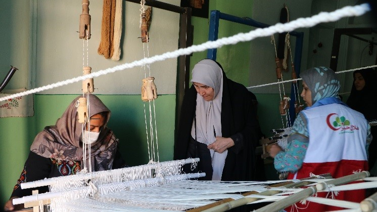 Women in Iran weave together to create various textiles for sale as part of an Empress Shoken Fund funded project, run by the Iranian Red Crescent Society, to support small businesses in rural communities.