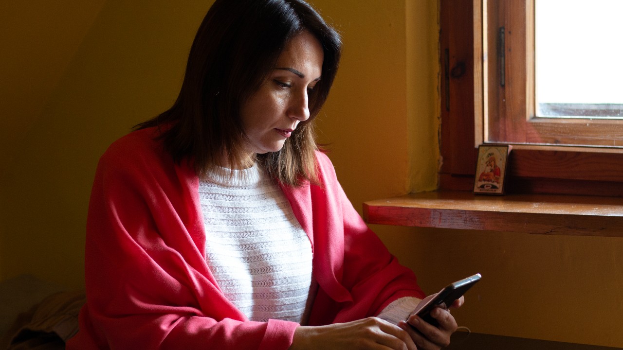 A woman from Ukraine who fled the conflict uses her phone at a Polish Red Cross lodge near Krakow.