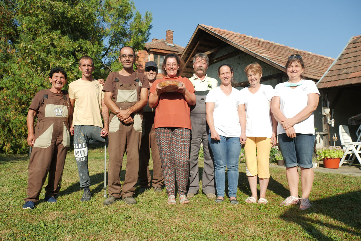 Molnárné, or Tünde as she is known, from Hungary stands with her team of farm workers at a small cheese factory set up by the Hungarian Red Cross to provide job opportunities to marginalised people.