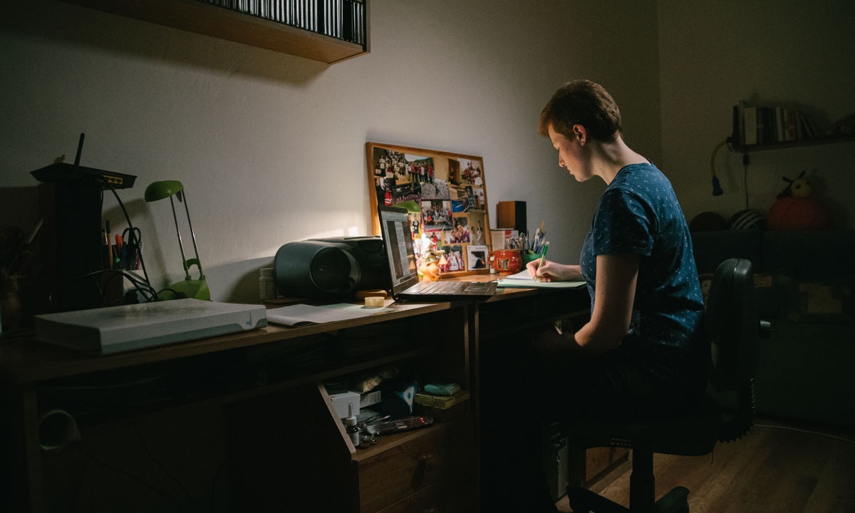Romy Mikušincová, a theoretical physics and astrophysics student and Red Cross volunteer, sits at her desk to study.
