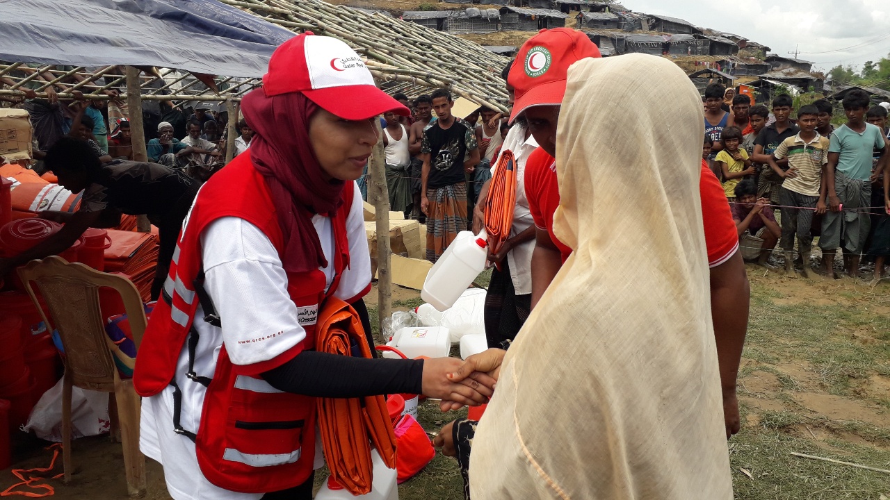 Reema from the Qatar Red Crescent speaks to a young woman in Cox's Bazaar camp to learn her story.
