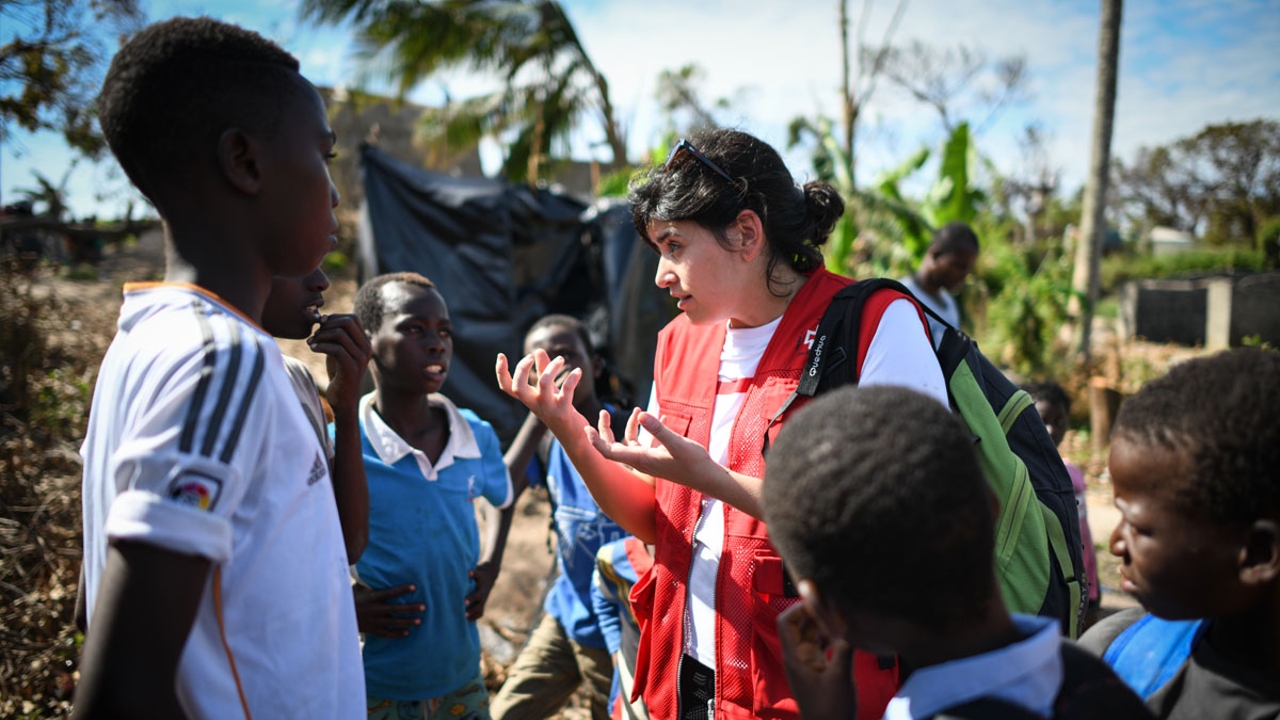 Eva Turró, a biologist with the Spanish Red Cross, speaks to a group of children in Beira, Mozambique about good hygiene after Cyclone Idai hit the region in 2019