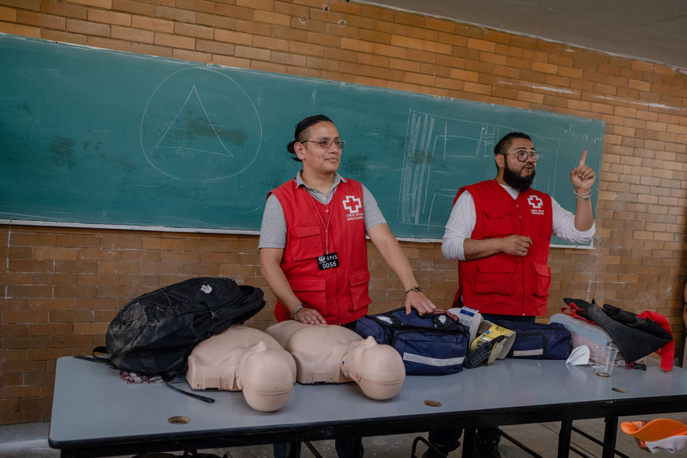 Two Mexican Red Cross volunteers teach first aid and CPR to detainees in a prison in Mexico City.