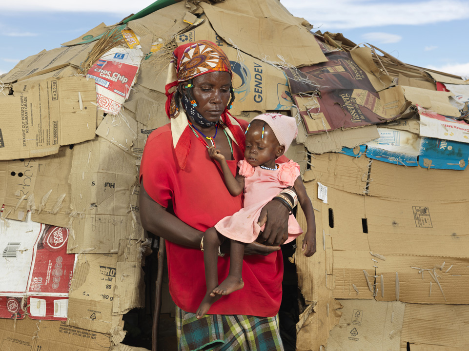 Deolinda from Angola holds her baby granddaughter who she carried on a ten-day trek to Namibia in search of food.
