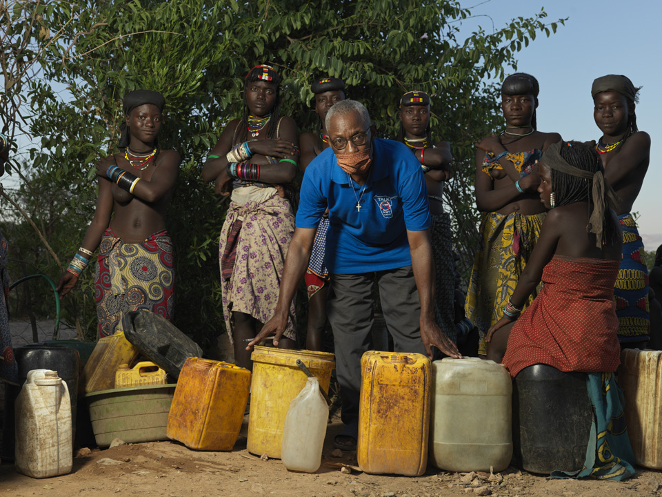 Konguari helps migrants arriving from Angola to access water by running a garden house from his house.