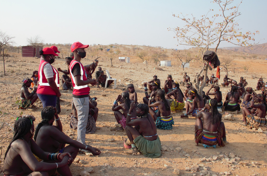 Namibian Red Cross Society volunteers speak to a group of people who have arrived on foot from Angola to escape drought conditions.