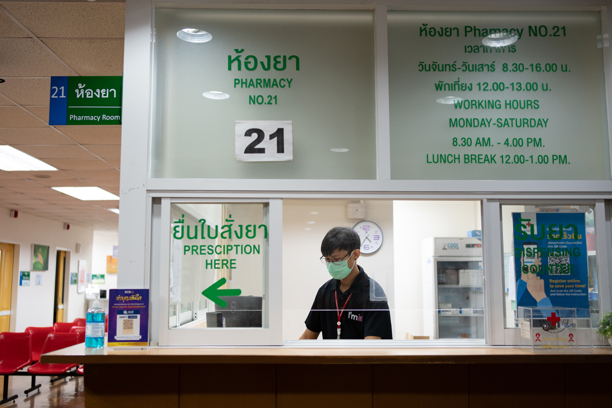 A health worker sits at the reception desk of the Anonymous Clinic to greet transgender people coming in seeking support.