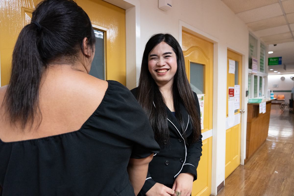 Naiyapak Chaipun, a counsellor at the Anonymous Clinic for transgender people in Thailand, greets a patient as they arrive. 