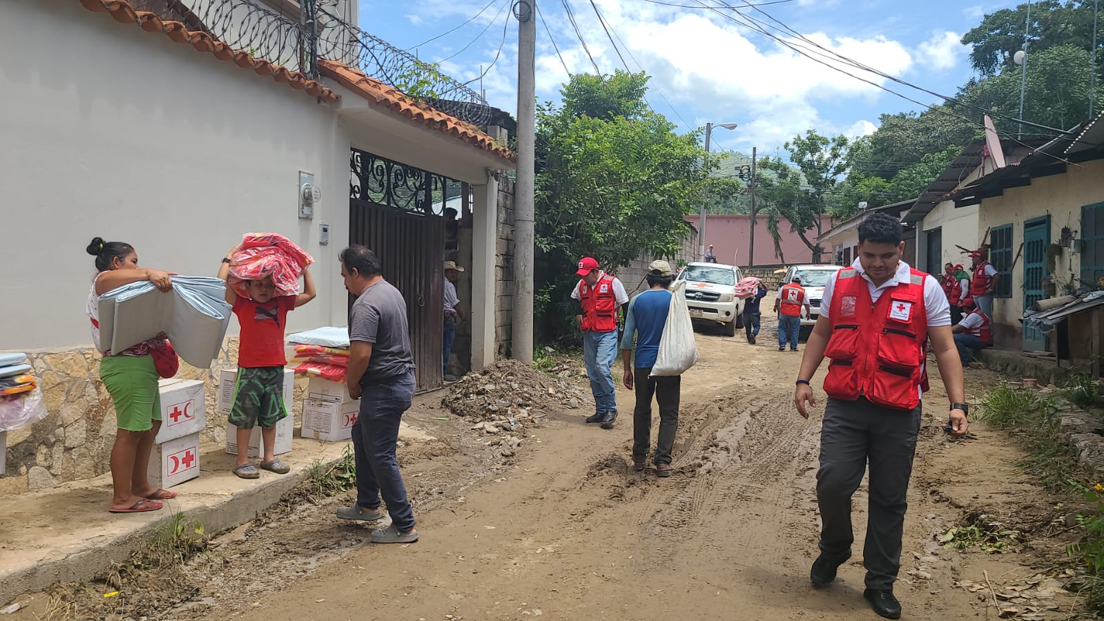 Honduran Red Cross volunteers hand out relief supplies to people in Copan Ruinas town following storms and floods in August 2023.