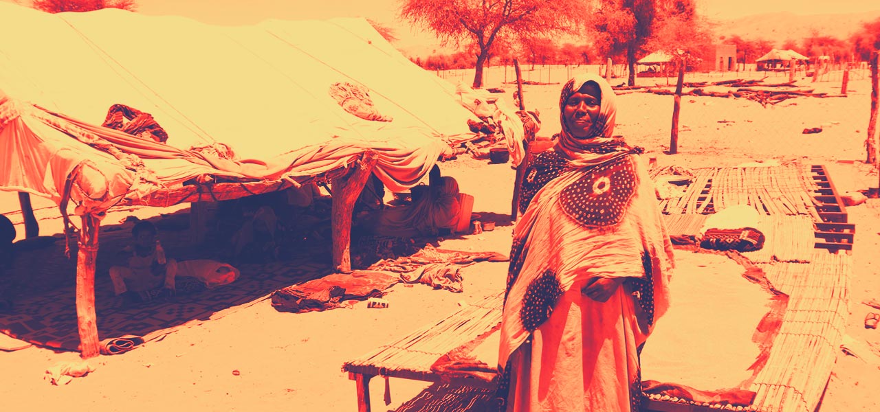 A woman from Barkeol department, Mauritania, stands near a tent where her local mothers' club meets to talk about their children's health and other key issues.