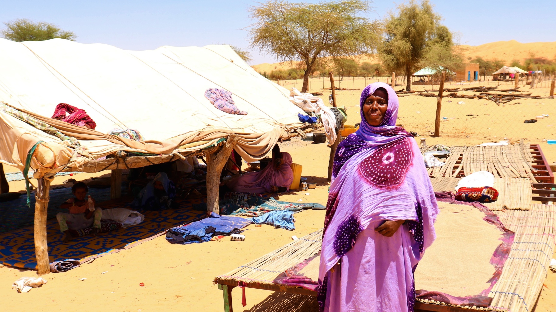 A woman from Barkeol department, Mauritania, stands near a tent where her local mothers' club meets to talk about their children's health and other key issues.