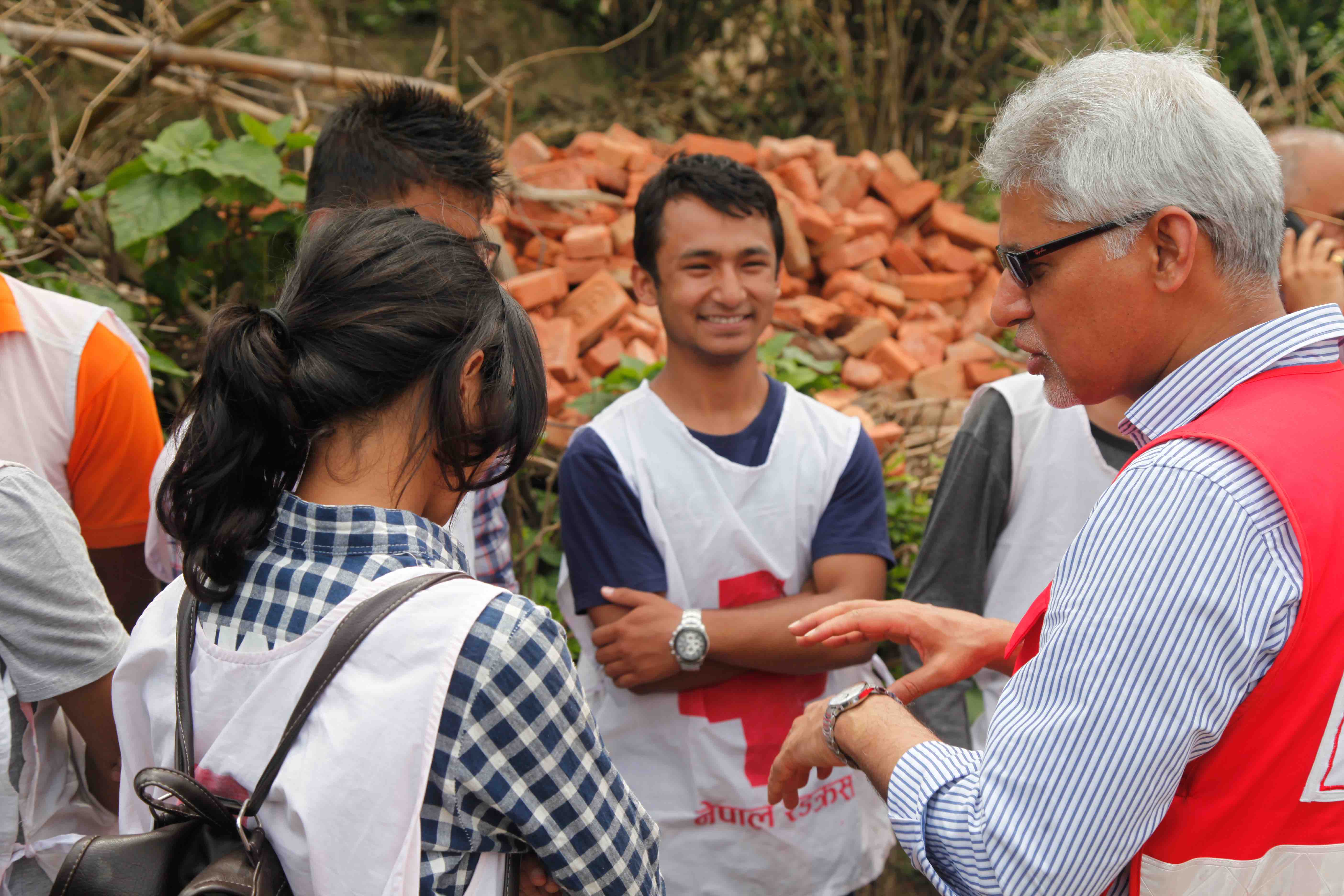 IFRC Secretary General, Jagan Chapagain, talks to young Nepal Red Cross volunteers during a visit to Nepal.