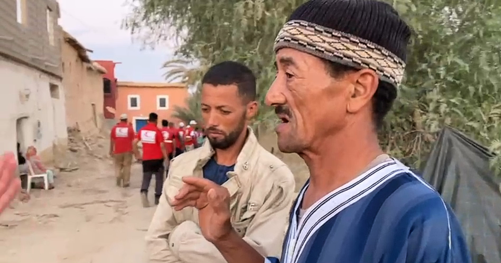Said's father, Mohamed, speaks to a Qatar Red Crescent volunteer in Tamaloukte about how he tried to save his grandchildren following the devastating earthquake. 