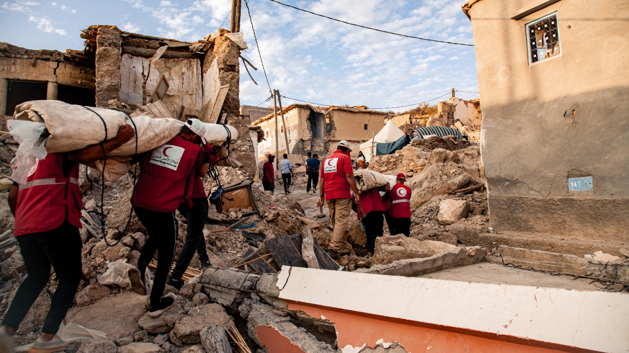 Moroccan Red Crescent volunteers carry tents and supplies into Tamaloukte village to provide shelter and urgent relief to families affected by the 8 September earthquake.