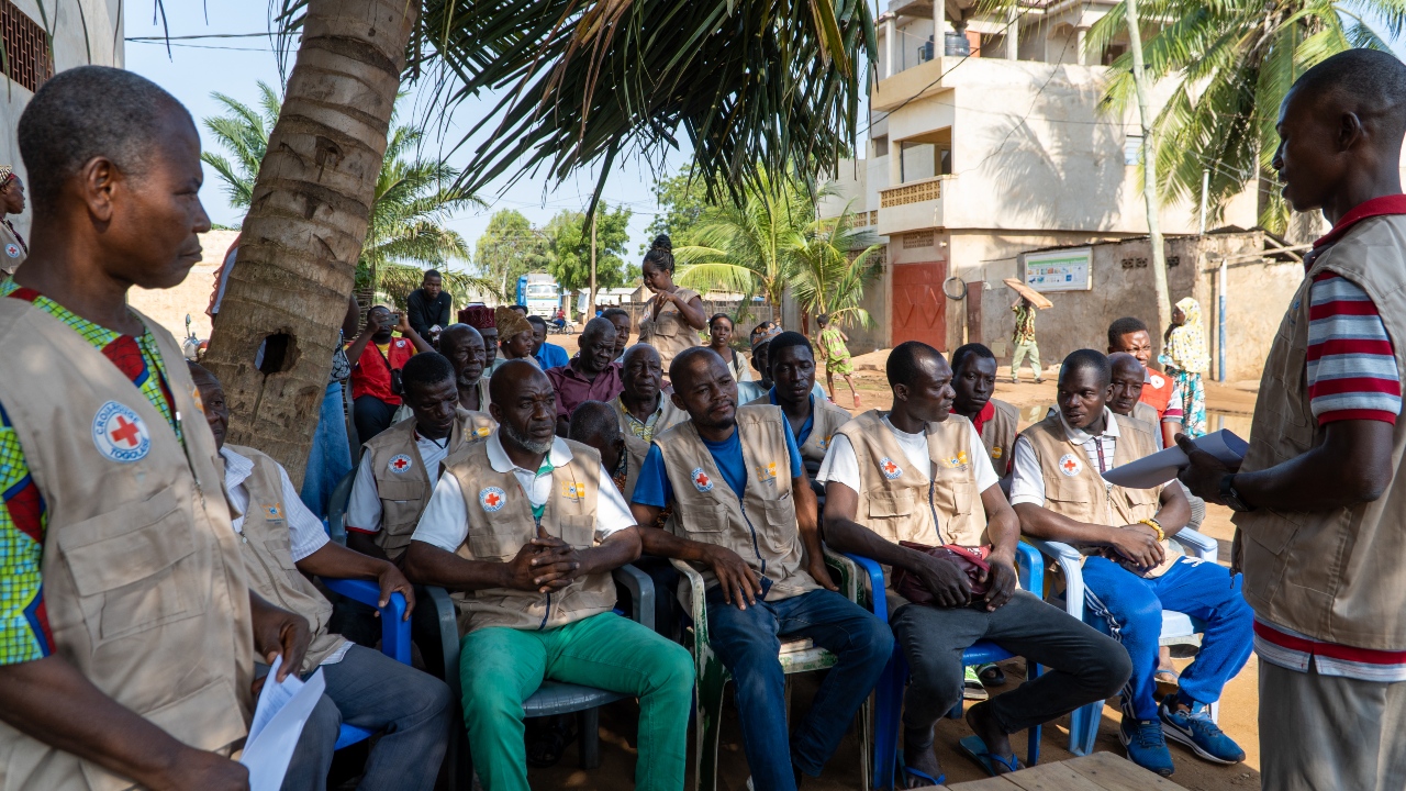 Togolese Red Cross volunteers and men from Togblékopé, Togo, take part in a Father's Club meeting to learn how they can champion women's rights.