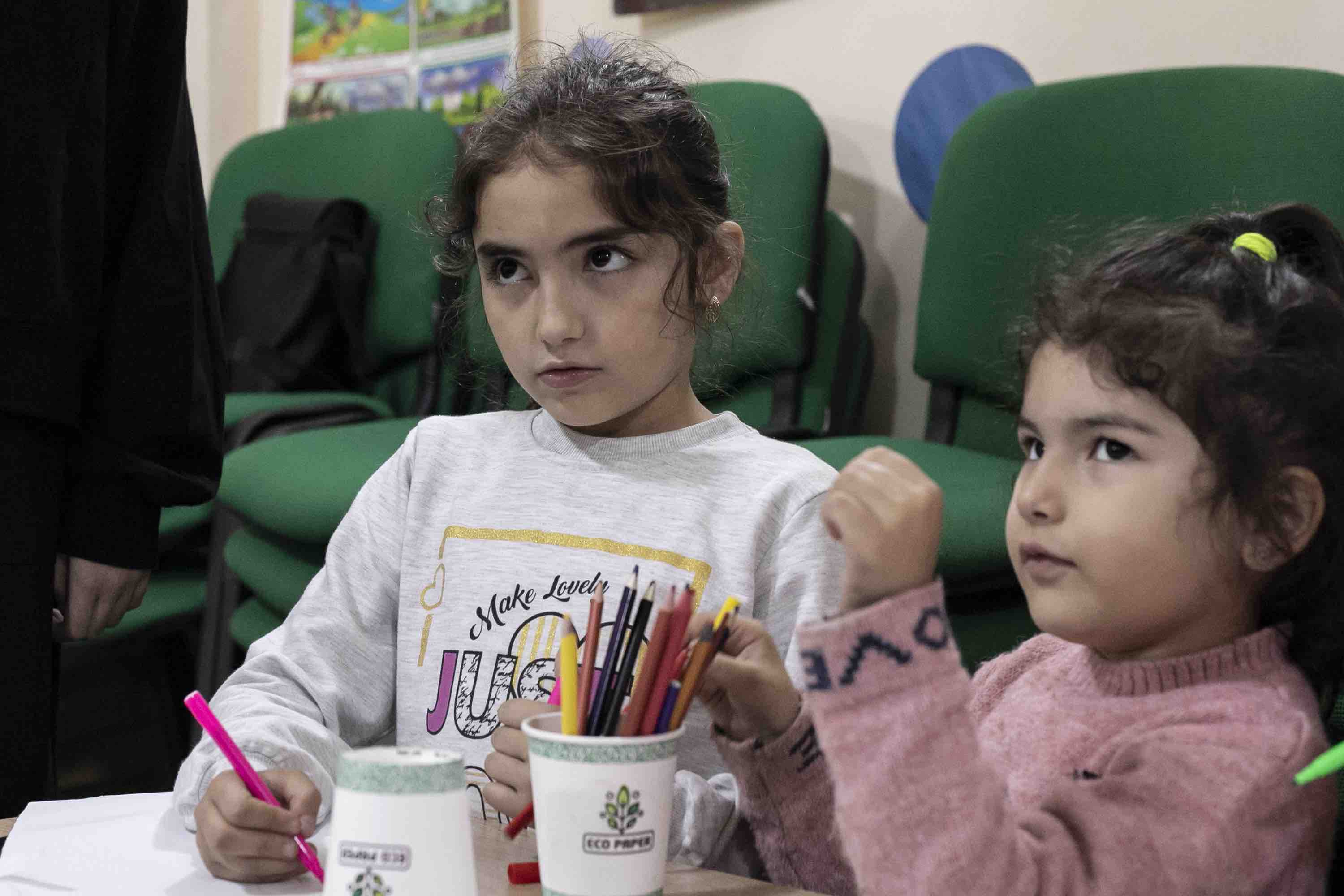 Mariana (9) and her sister Lucia (5) at the Smiley Club, one of 28 child-friendly spaces managed by the Armenian Red Cross.