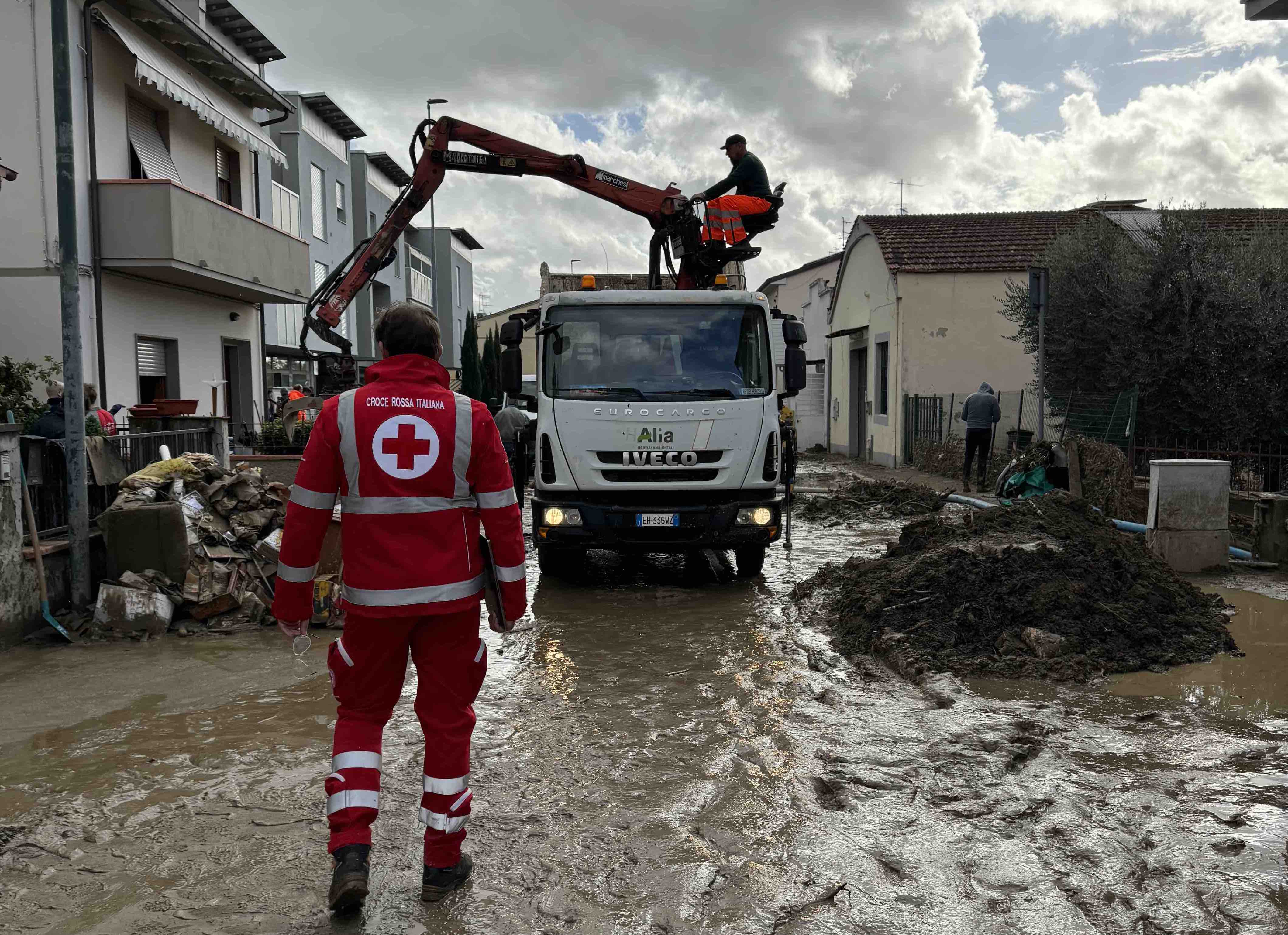 Italian Red Cross teams help dig out after a mudslide induced by heavy rains.
