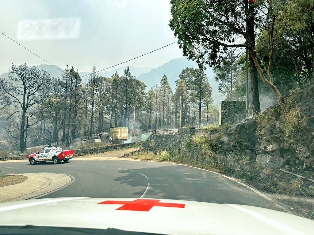 A Spanish Red Cross team arrives at the aftermath of wildfires.