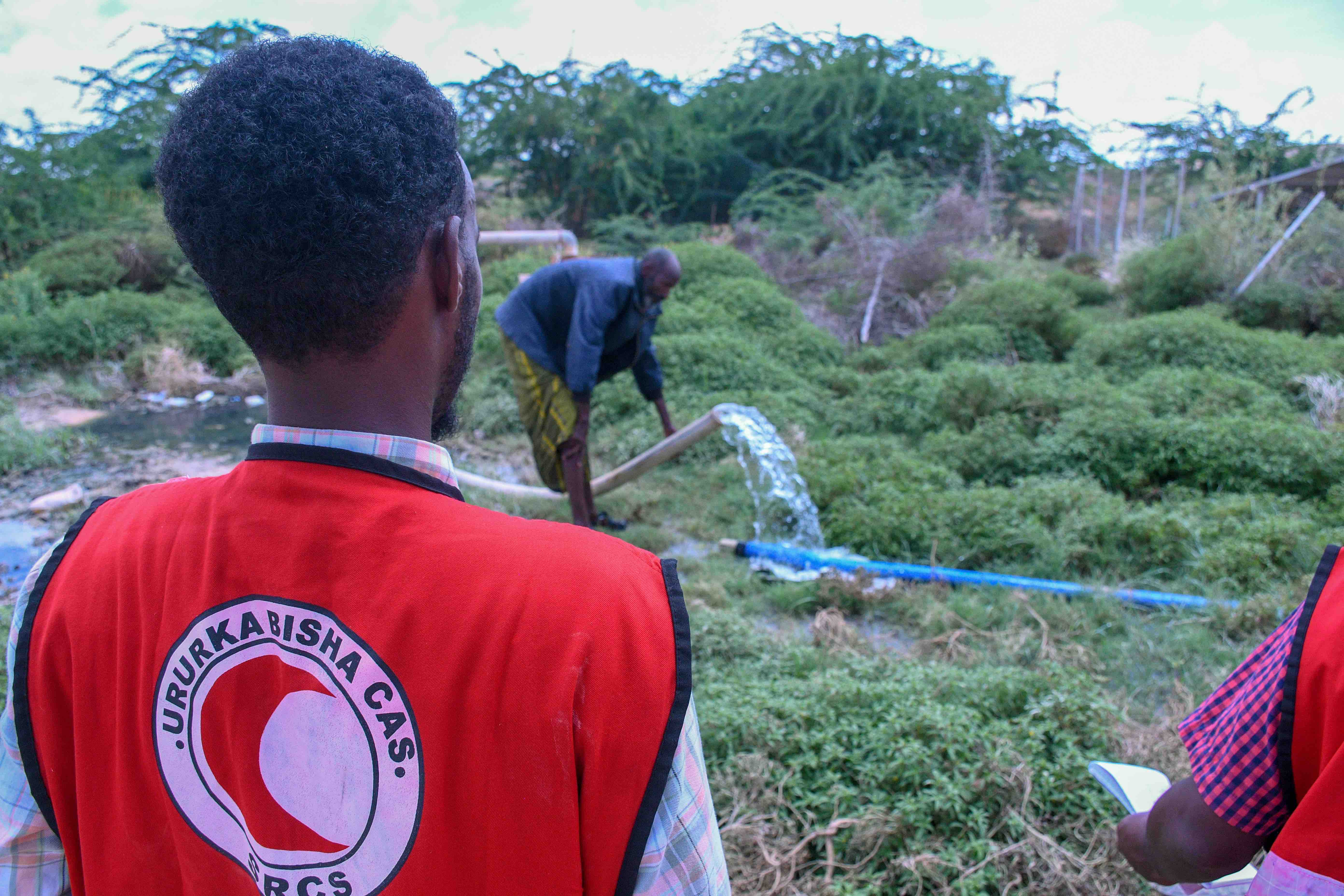 Water gushes from a pipe connected to a borehole recently re-furbished by the people of Cuun village, the Somali Red Crescent and the IFRC.