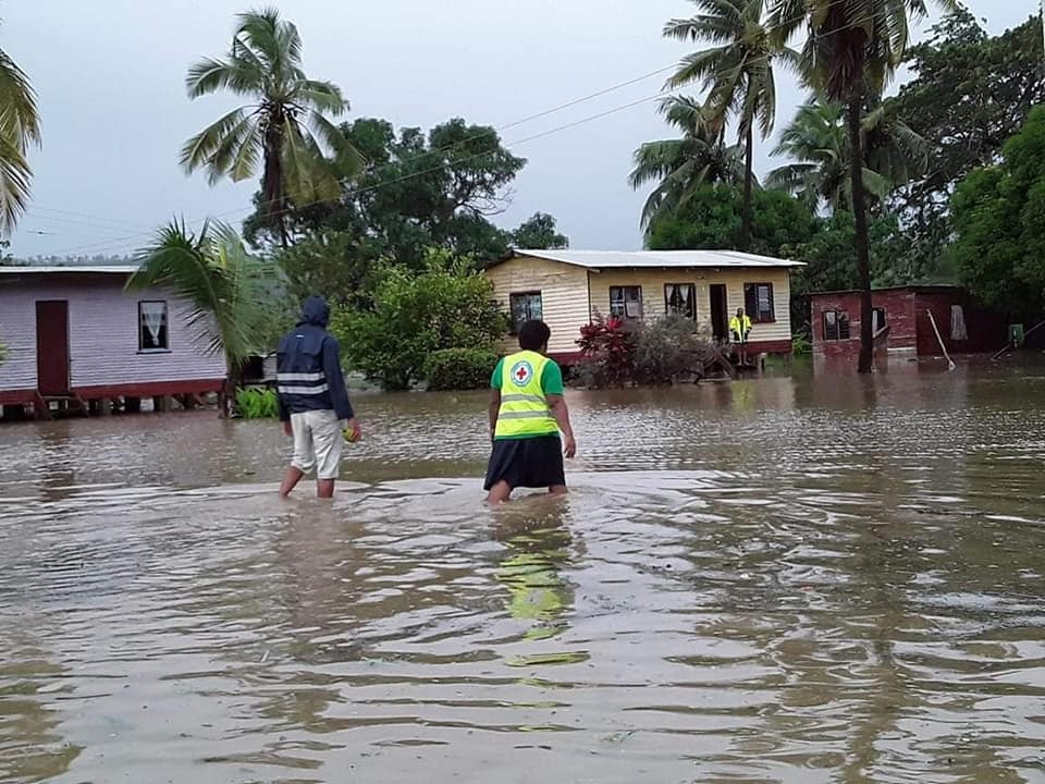 Fiji Red Cross volunteer wades in to help communities hit by storm surges and rising tides.