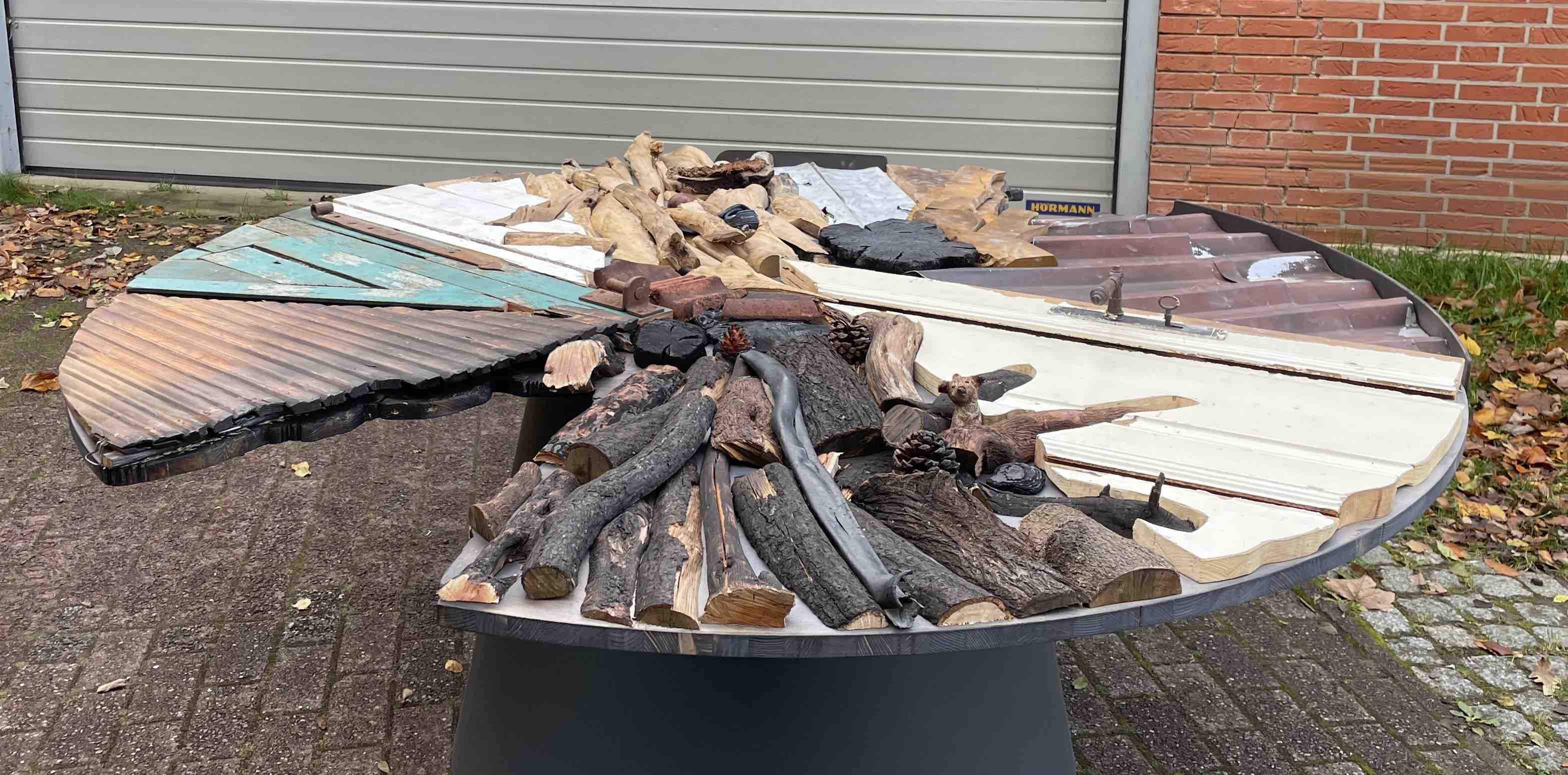 The Reclaimed Table for Climate Action is made of debris from climate-related disasters all around the world.