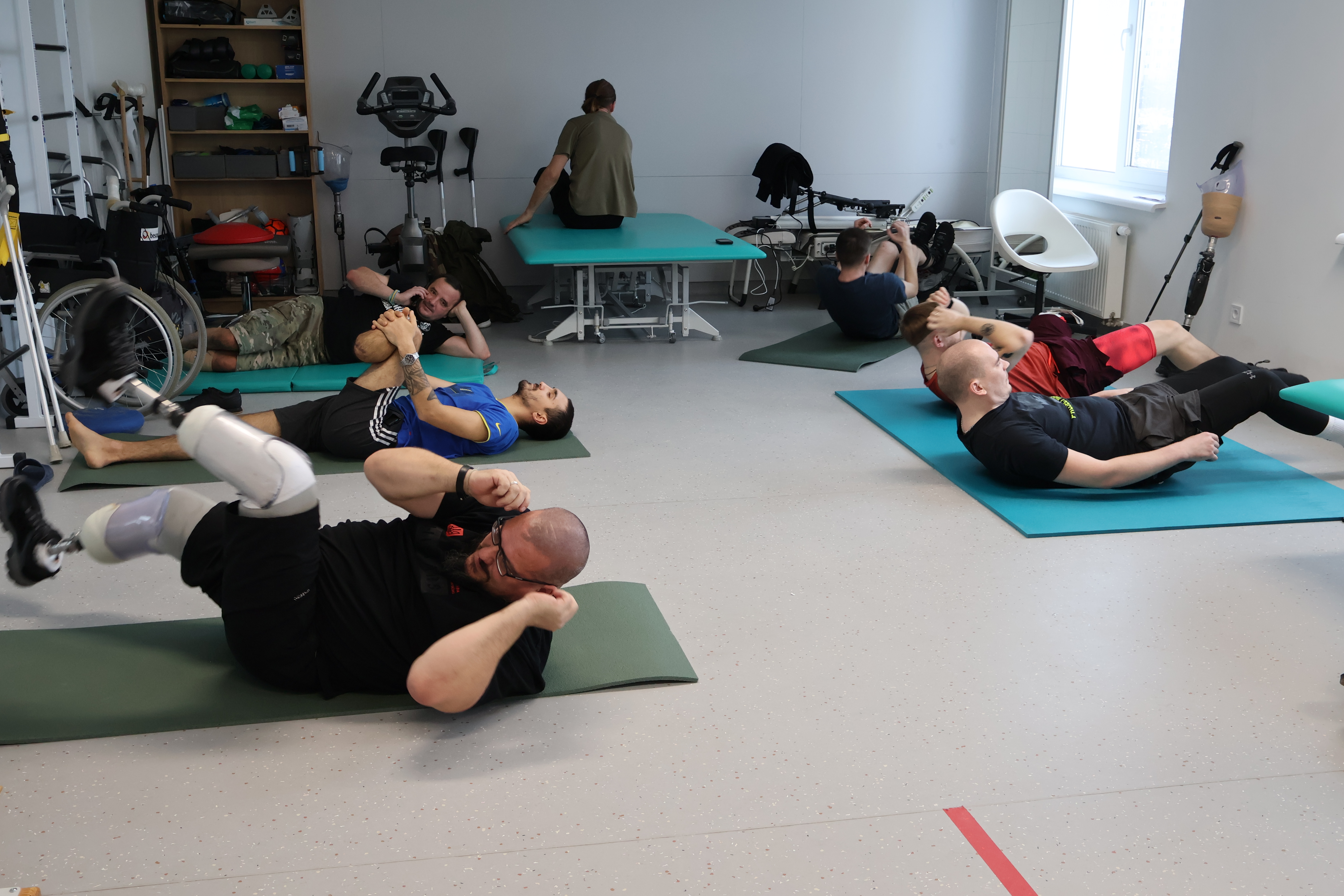 Serhii (left) lost both his feet to landmines. Now with prosthetics, he works out in the exercise room at the Unbroken Centre in Lviv, Ukraine.