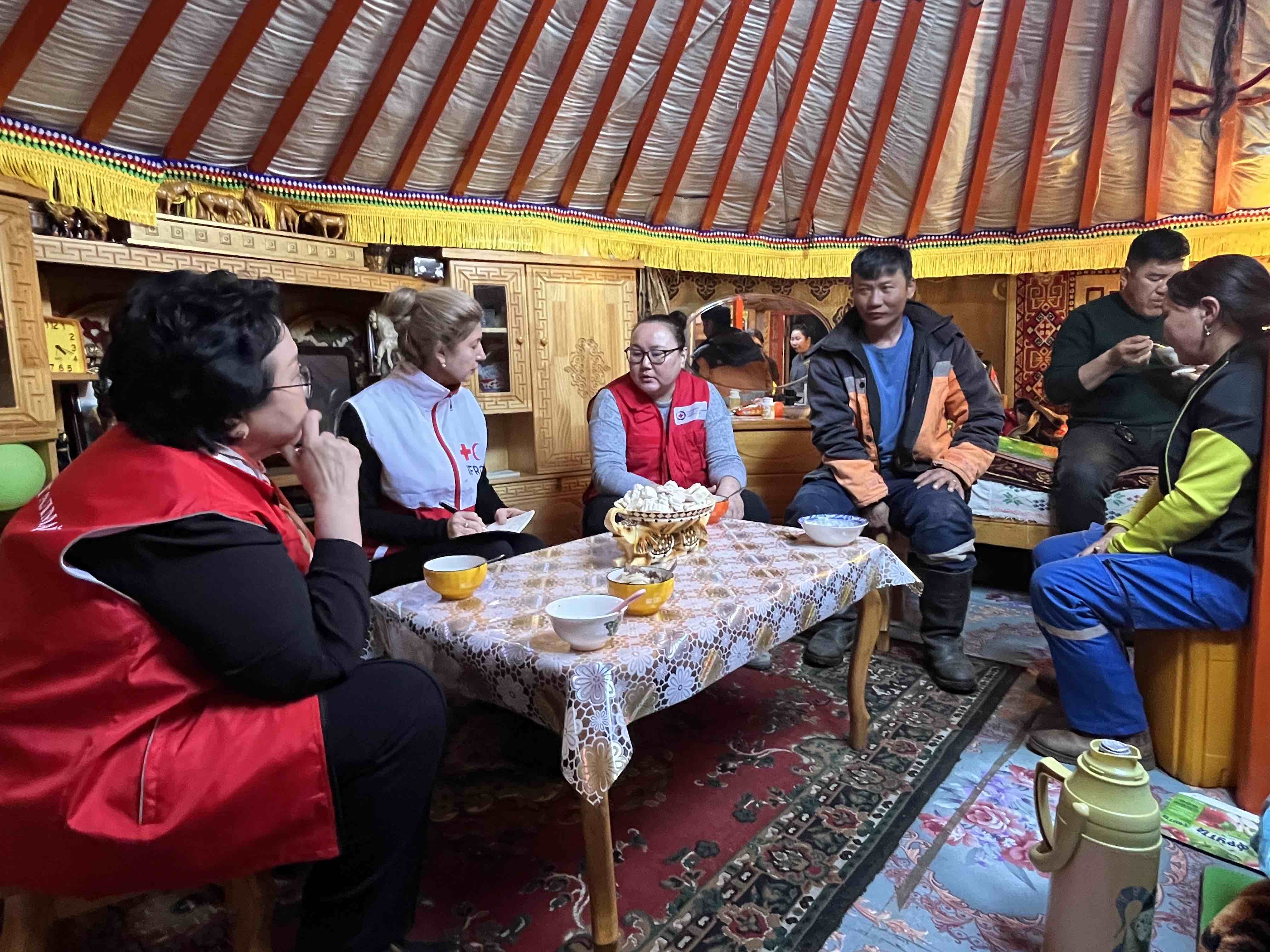 Olga Dzhumaeva (second from left), head of IFRC's East Asia Delegation, joins the Mongolian Red Cross in a meeting with Tumurzurkh S., a herder from Dornod province who explains how extreme and cold have impacted his family.