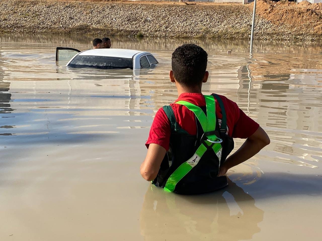 Water, water everywhere, but even during major floods, clean water can be very hard to find. Here, a volunteer with the Libyan Red Crescent wades into flood waters in the days following floods caused by Storm Daniel in September 2023.