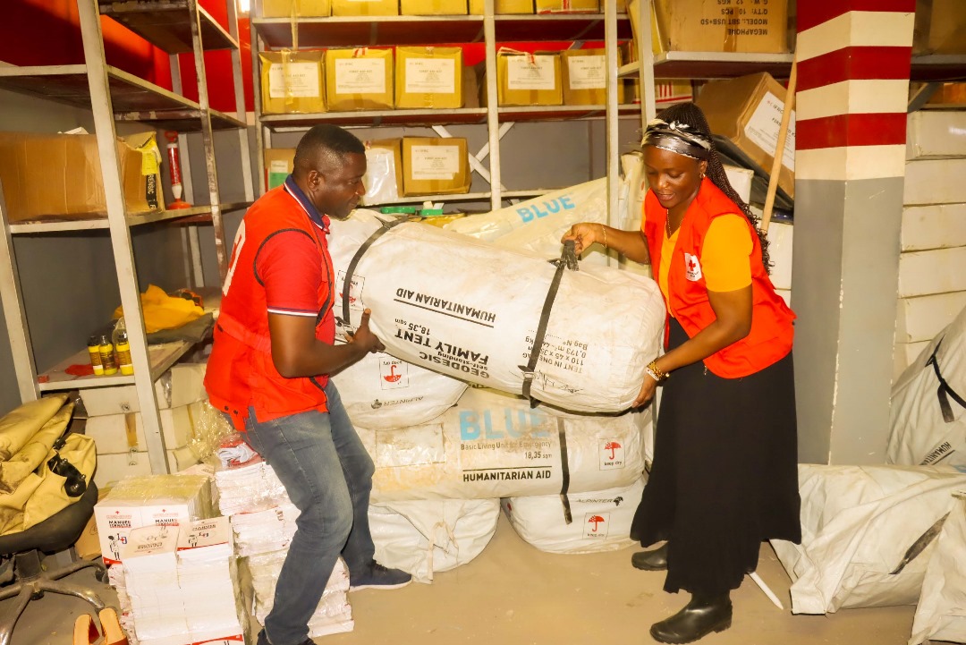 Gloria Lombo, secretary general for the Red Cross of the Democratic Republic of the Congo, does some heavy lifting during a recent aid distribution.