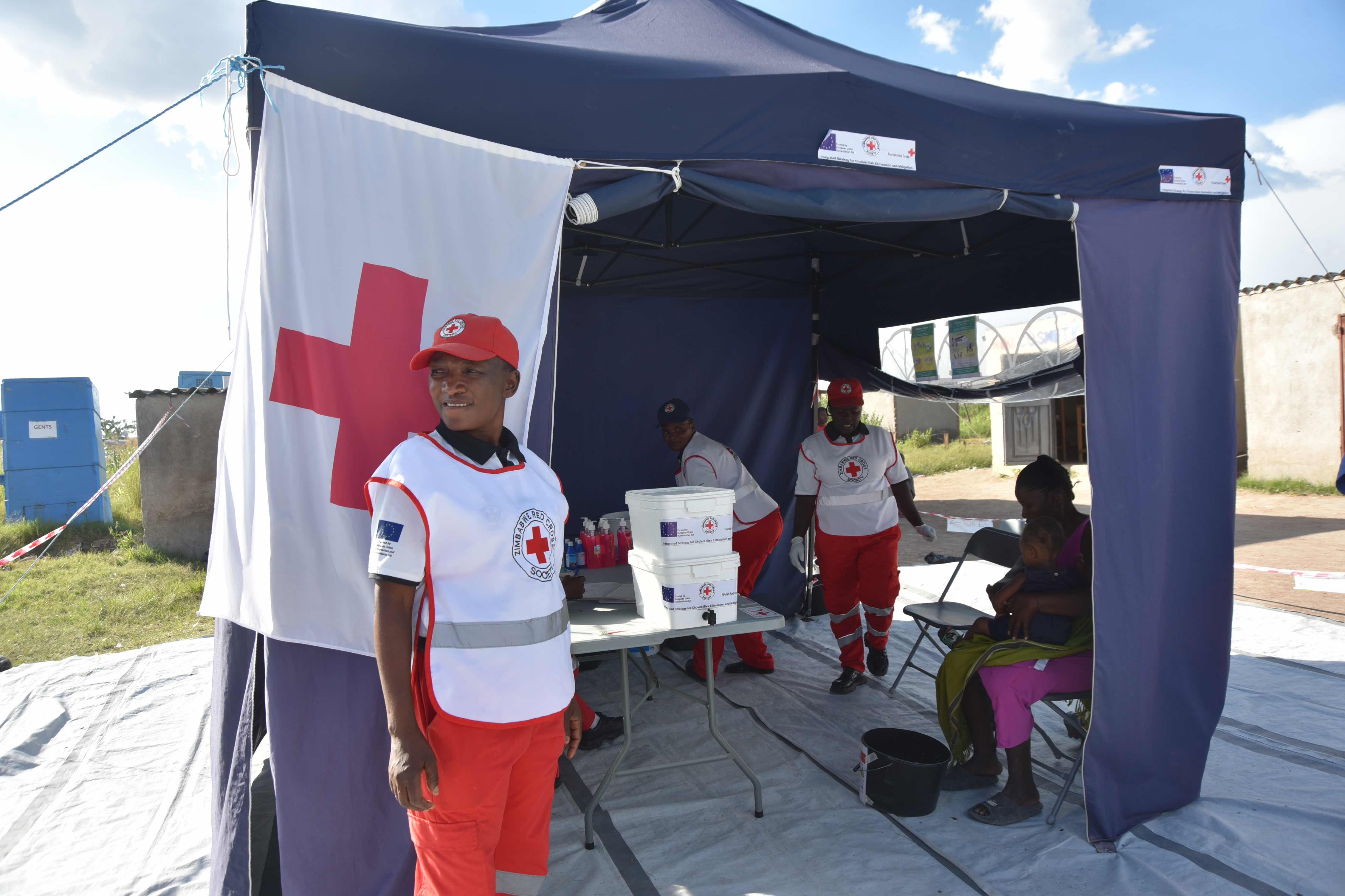 Zimbabwe Red Cross Society volunteers tend to a community member at the Oral Rehydration Point (ORP) in Hopley Farm in Harare, Zimbabwe.