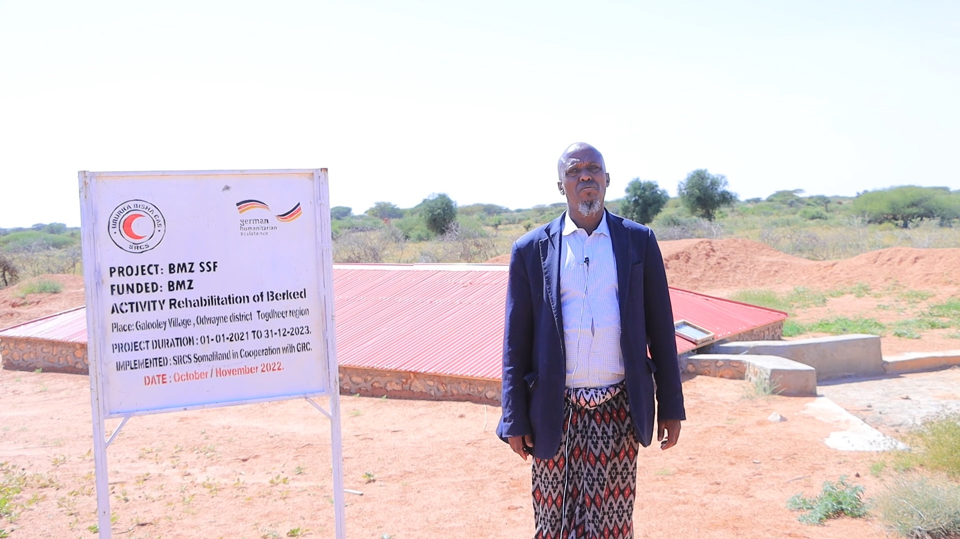Asad Abdilahi Heri, the village head in Galoolay stands in front of a berked (traditional underground water cistern), refurbished by the community through an SRCS programme supported by the German Red Cross