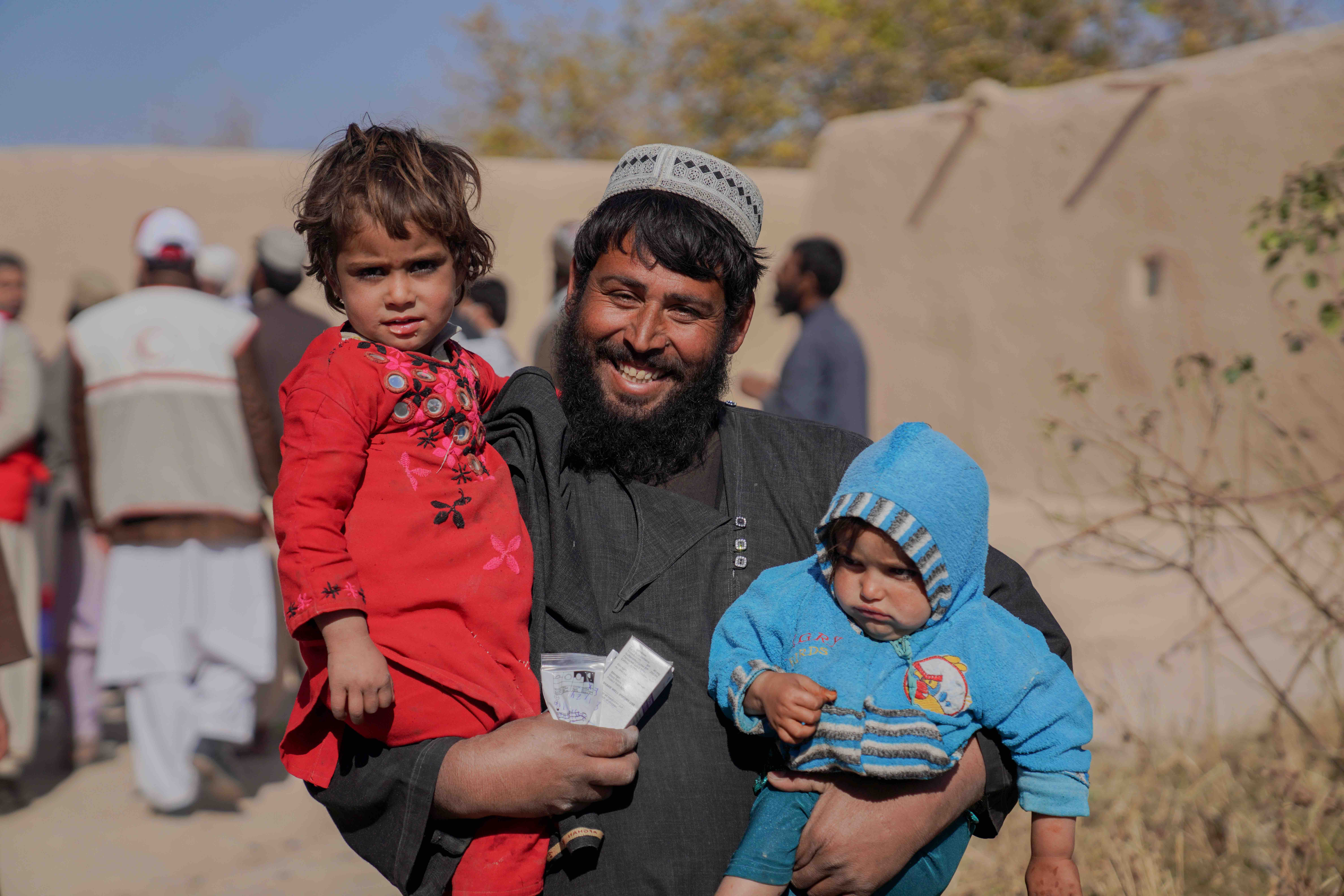 Muhammad Taher, a 40-year-old farmer, brings his family of eight children  to a mobile clinic run by the Afghan Red Crescent, much like thousands of others in rural, remote parts of the country.