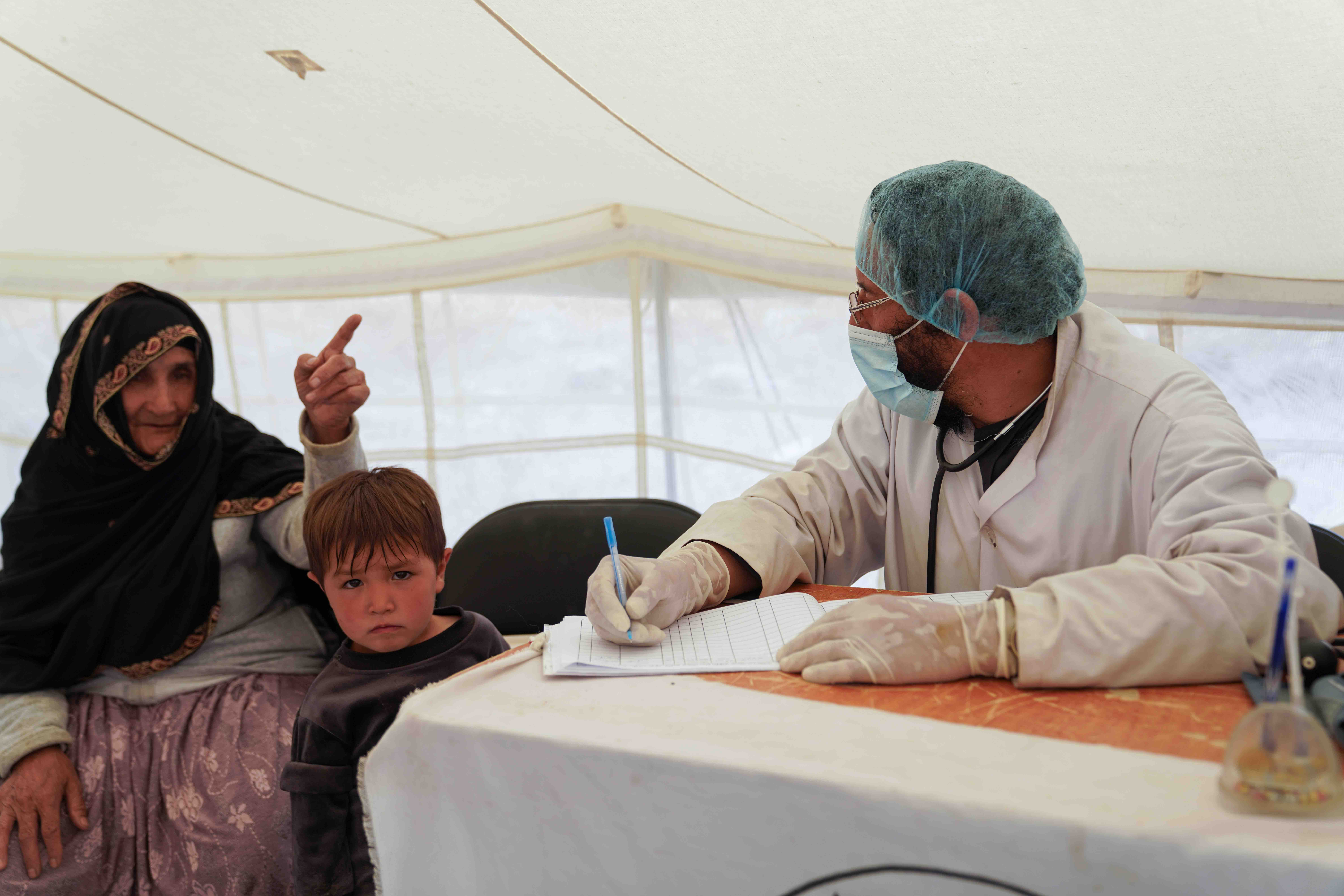 The Afghan Red Crescent mobile health teams also provide services in the wake of emergencies. Here a woman and child visit a mobile clinic following floods in July 2023 that affected nine provinces.