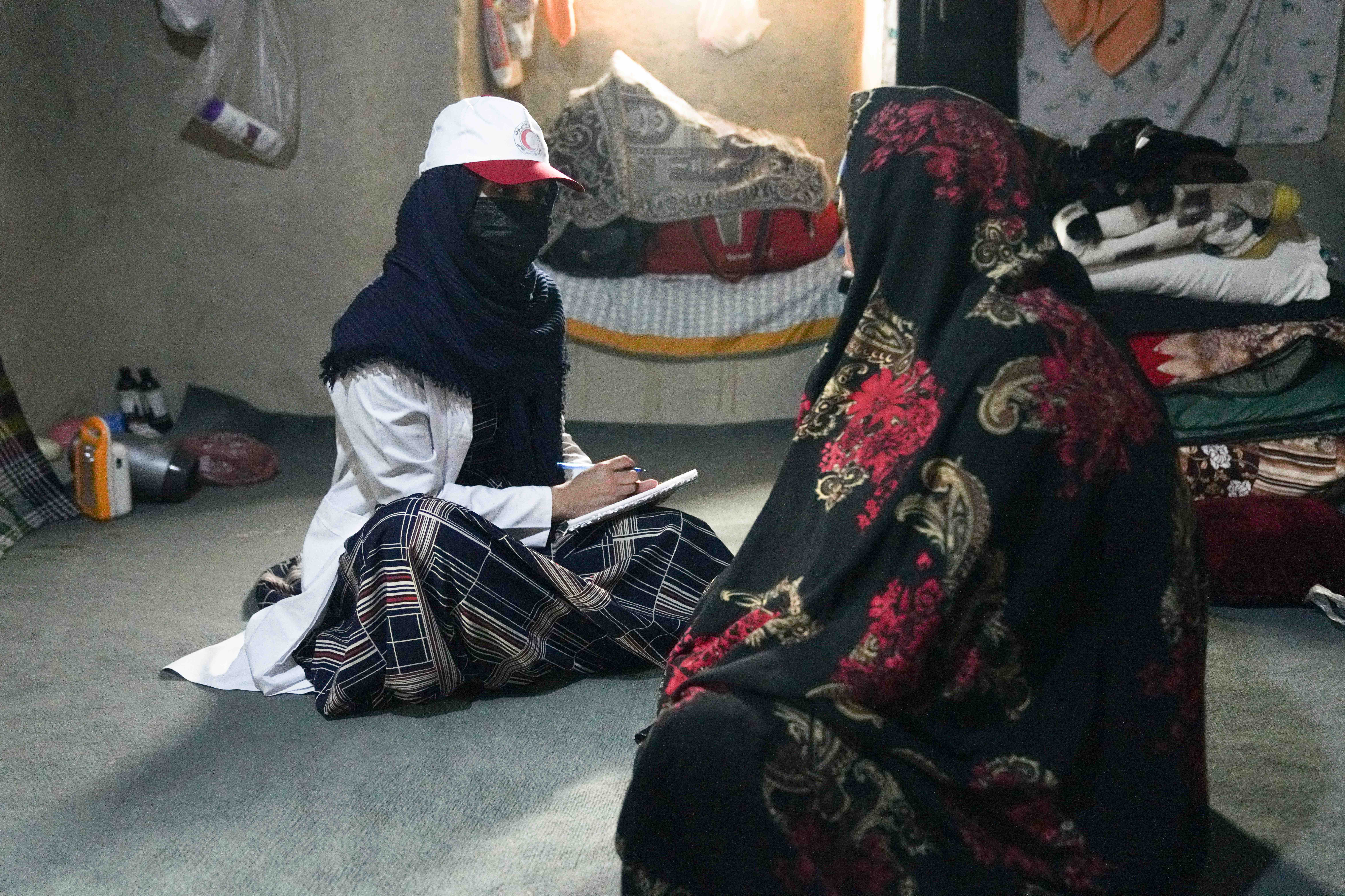 Women make up a large portion of the mobile health clinic teams and they play a very important role, particularly regarding the health of women in remote communities. Here a woman staff member of the Afghan Red Crescent mobile health team does a consultation with a woman in Helmand province.  
