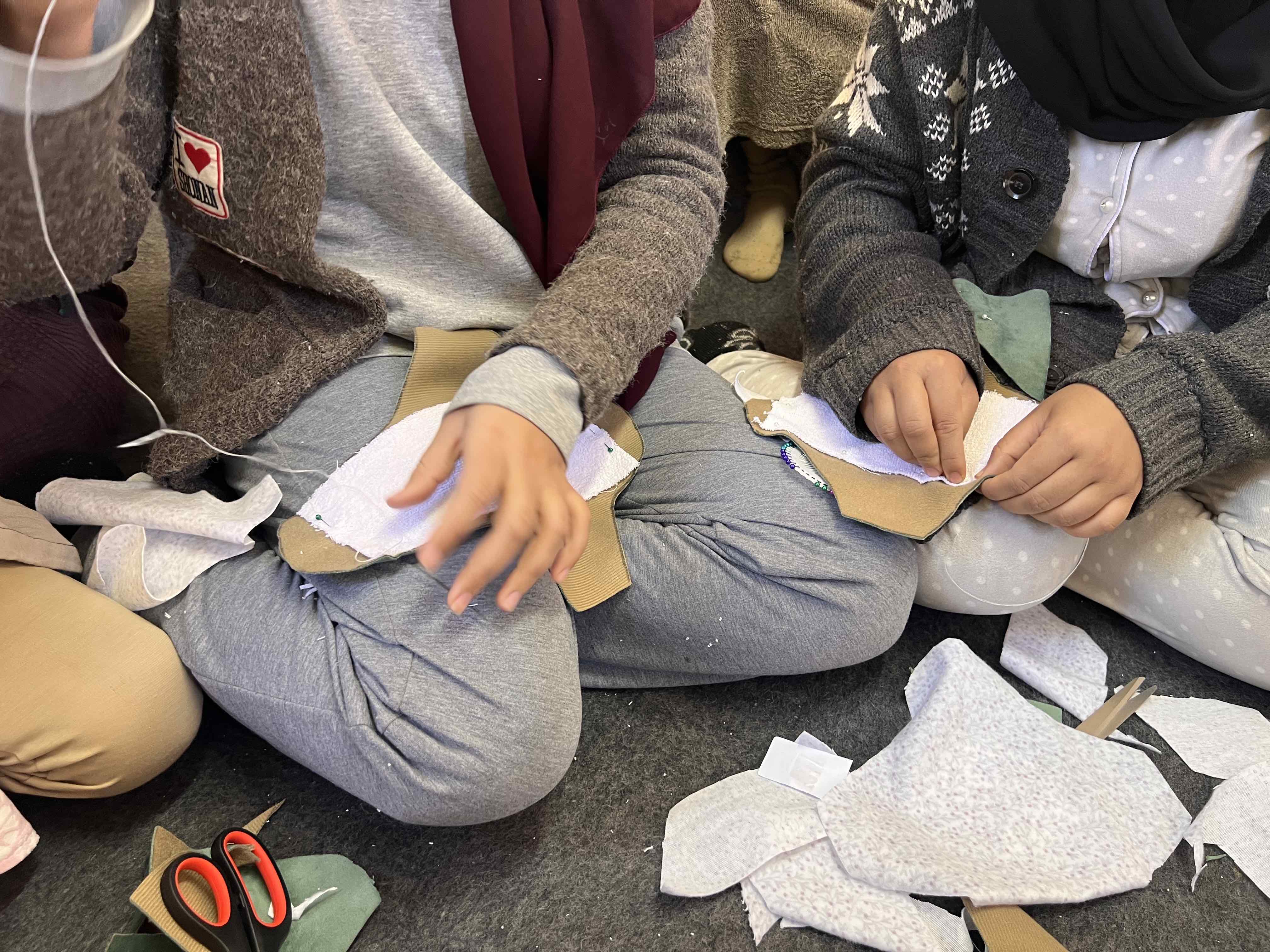 Women sew their own sanitary pads by hand in a workshop organized by the Moroccan Red Crescent and the IFRC.