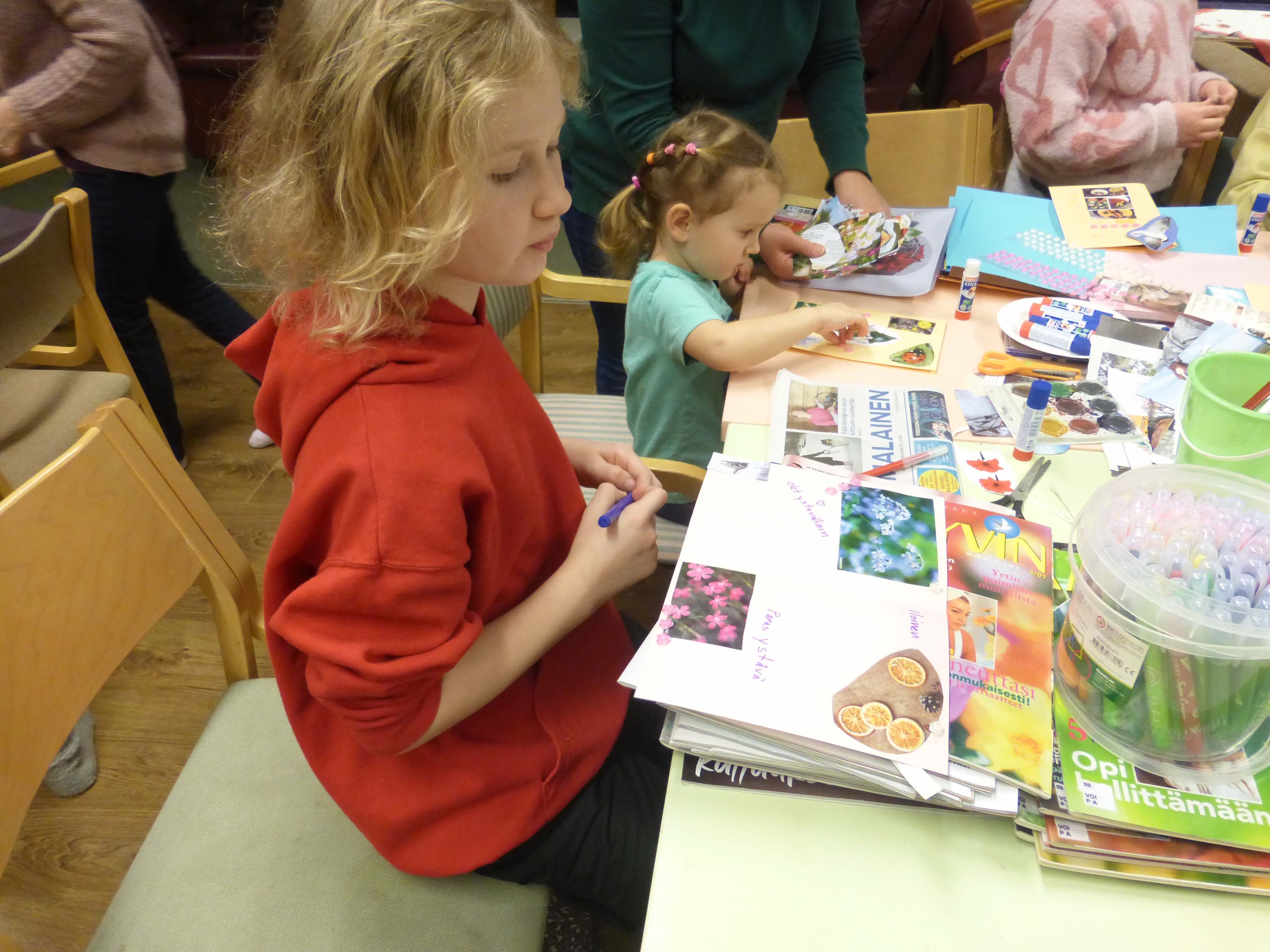 Using coloured pencils, markers and images cut from magazines, children make colorful greeting and thank-you cards as part of an art therapy project for Ukrainian children run by the Finnish Red Cross.