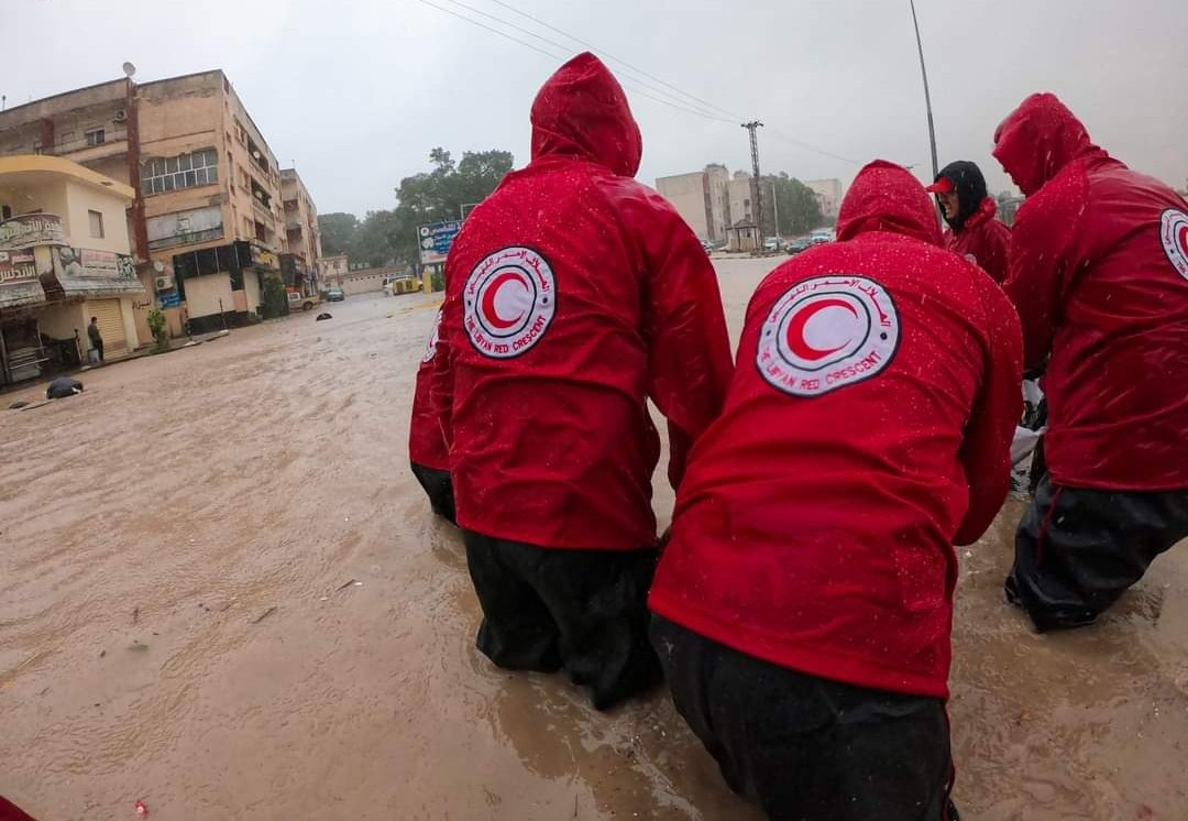 Training, preparation and investment before a disaster strikes are critical so that teams like this one — Libyan Red Crescent volunteers wading through waist-high water after a sudden flood in September 2023 — can save lives effectively and safely. 